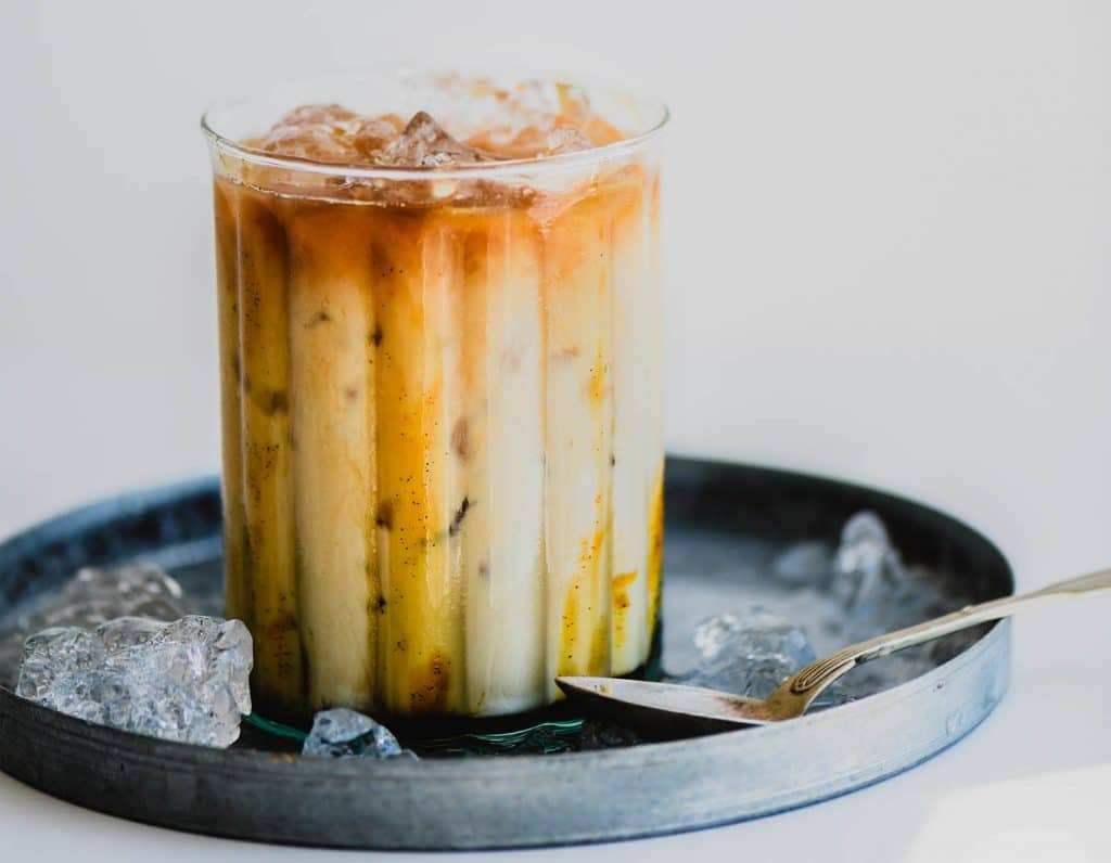 Iced caramel macchiato coffee with caramel syrup in glass