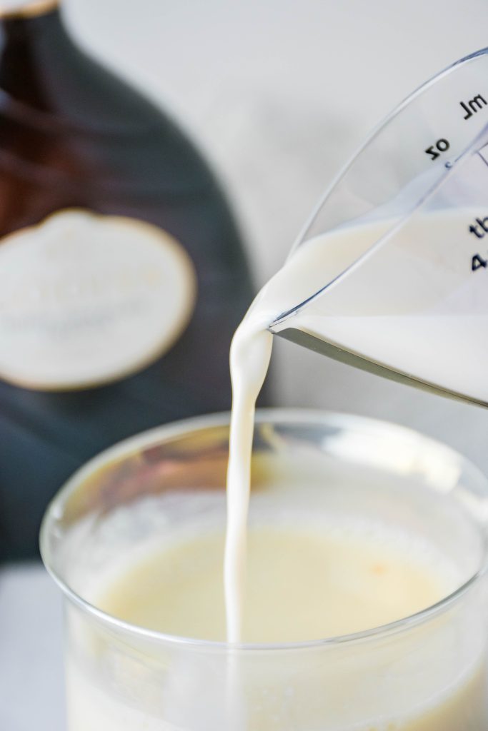 boozy white hot chocolate poured into a glass