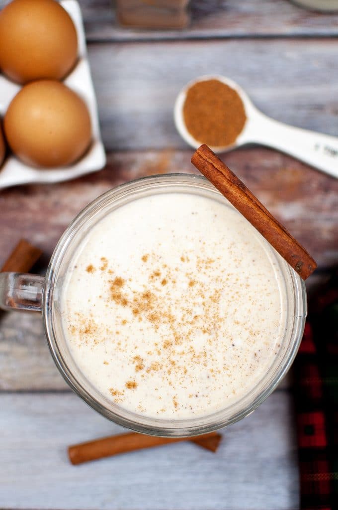 overhead shot of homemade eggnog recipe with cinnamon stick