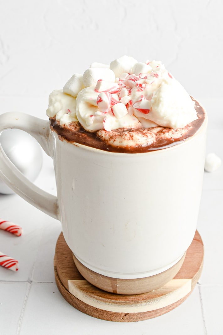 Peppermint hot chocolate with marshmallow and candy cane sweets in