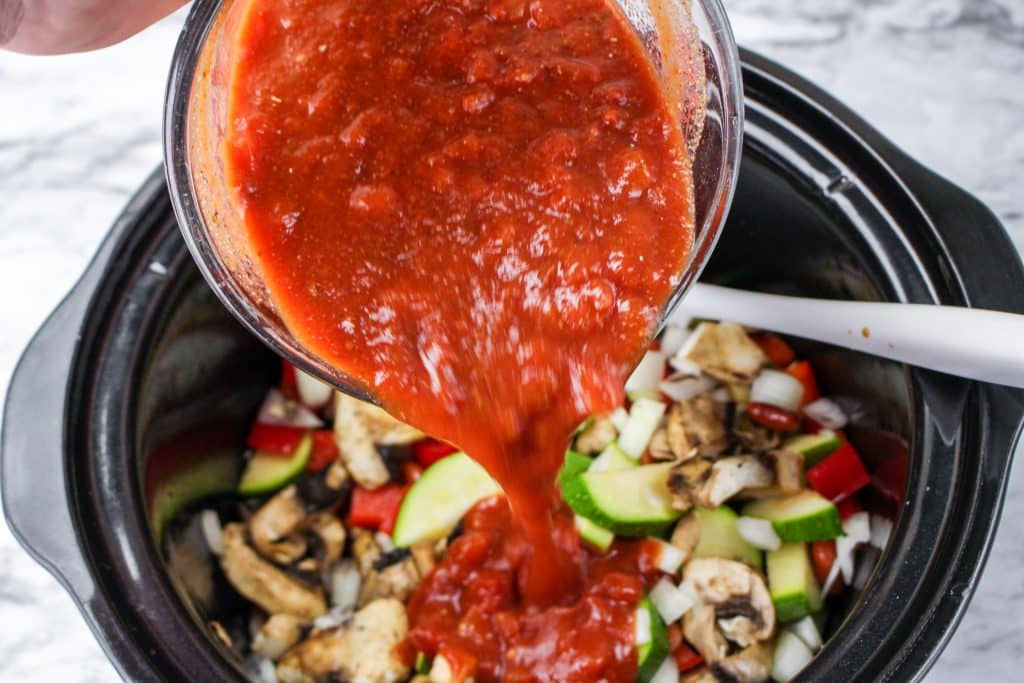 pour the sauce over the veggies in the slow cooker